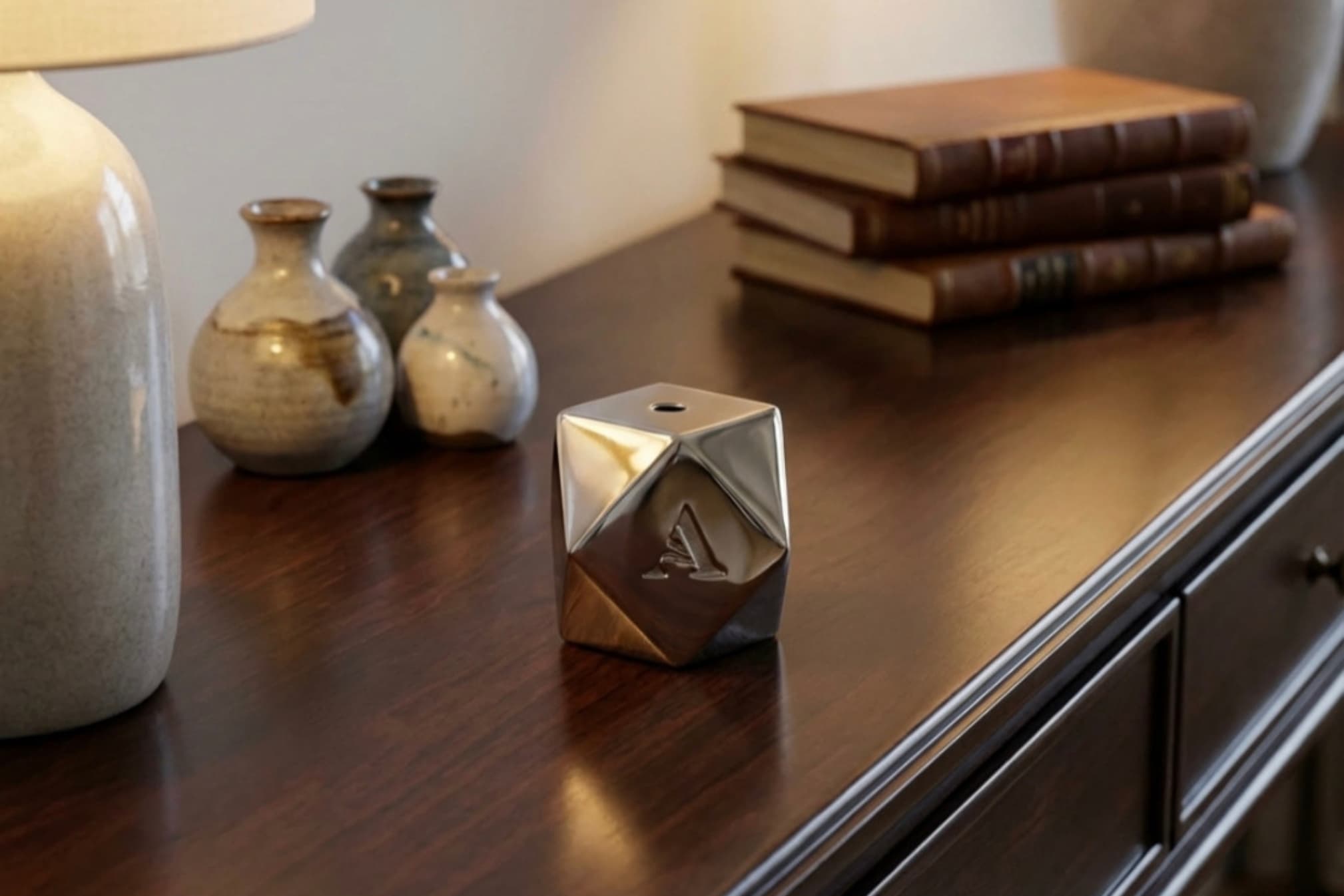 Close-up of the nickel-plated Hexagon incense burner's high-shine finish and hexagonal facets.