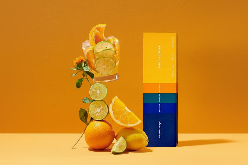 Artisanal Delight incense sticks displayed with fresh Mandarin oranges and Rosemary sprigs to highlight the active ingredients.
